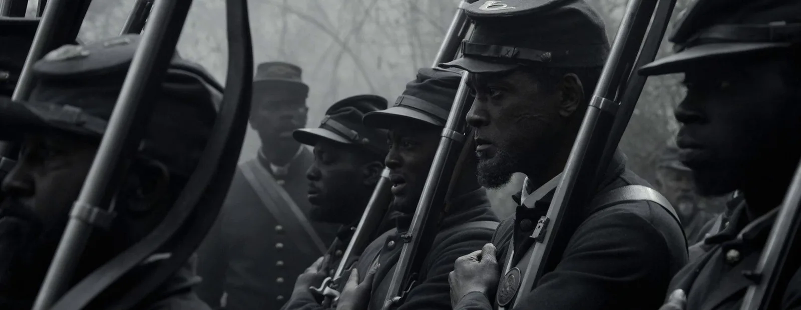 This shot profoundly captures a line of resolute soldiers, focusing sharply on a